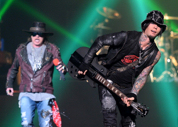 LAS VEGAS, NV - MAY 21:  Singer Axl Rose (L) and guitarist Dj Ashba of Guns N' Roses perform at The Joint inside the Hard Rock Hotel & Casino during the opening night of the band's second residency, "Guns N' Roses - An Evening of Destruction. No Trickery!" on May 21, 2014 in Las Vegas, Nevada.  (Photo by Ethan Miller/Getty Images)